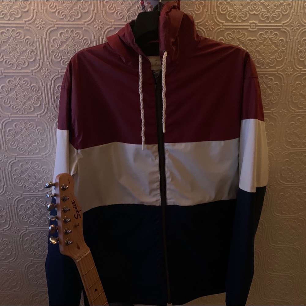 maroon, white, and navy wind breaker.